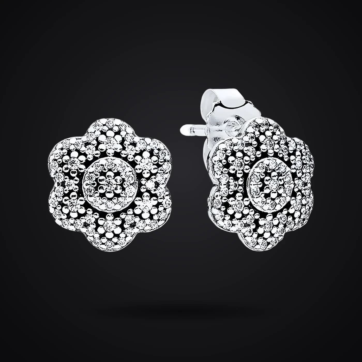 Snowflake earrings on a dark background