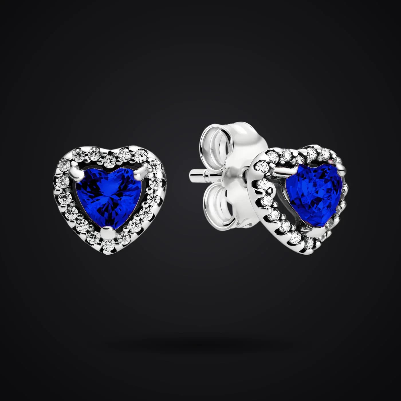 Blue Hearts earrings on a dark background