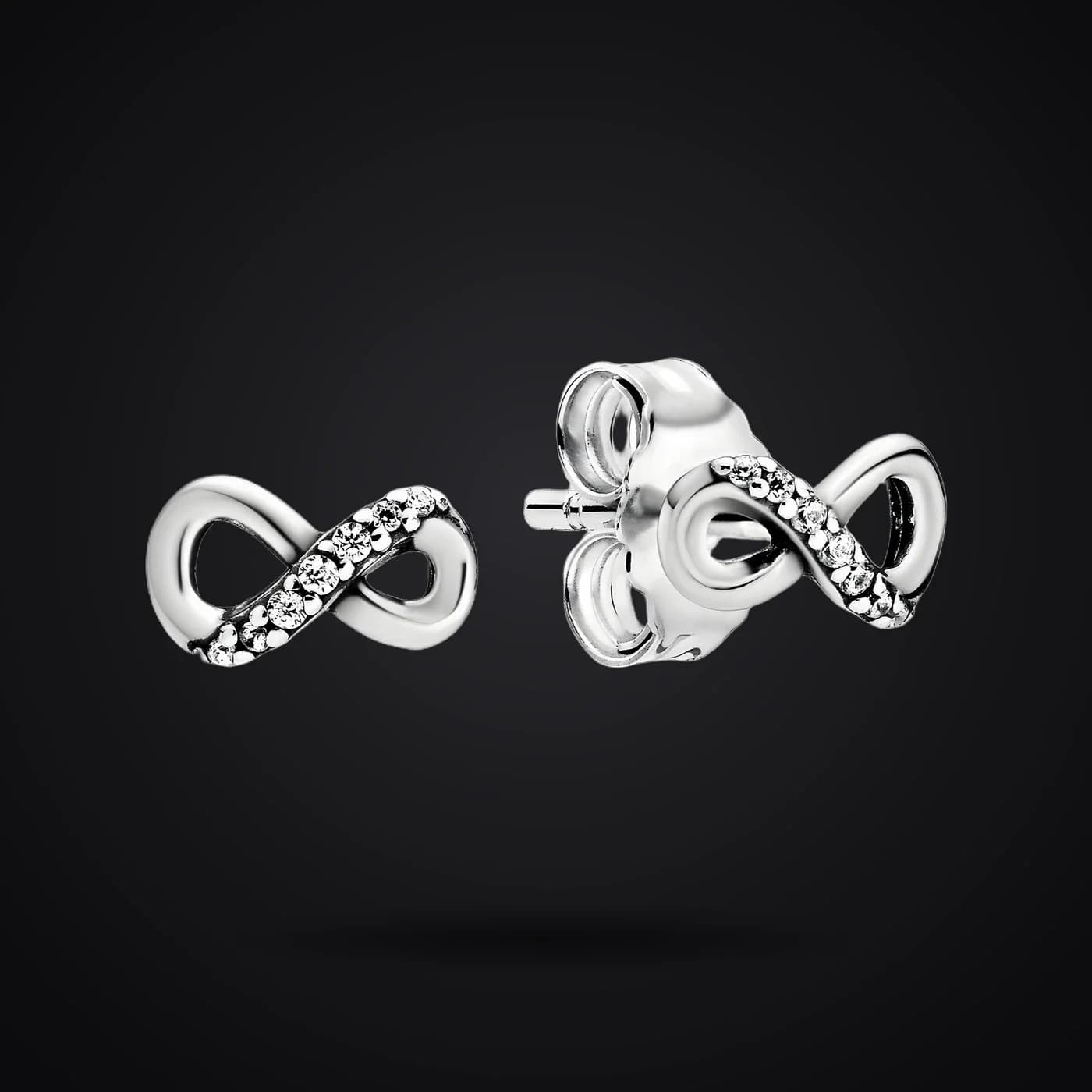 Infinity earrings on a dark background