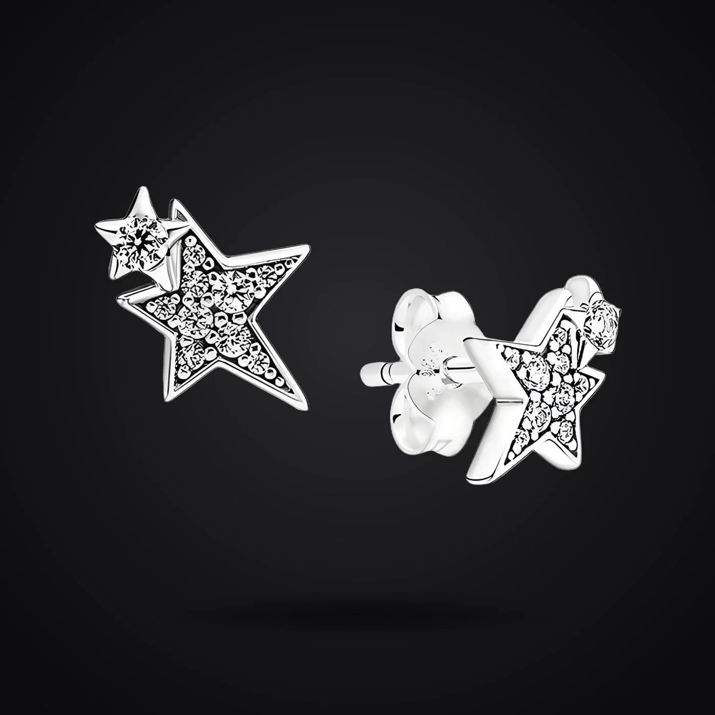 Asymmetric Stars earrings on a dark background