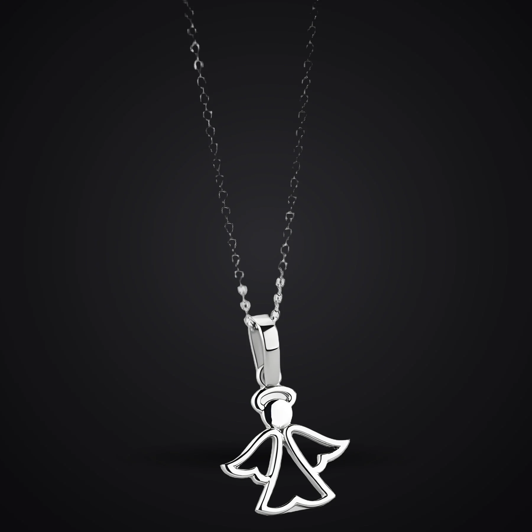 Little Angel necklace on a dark background