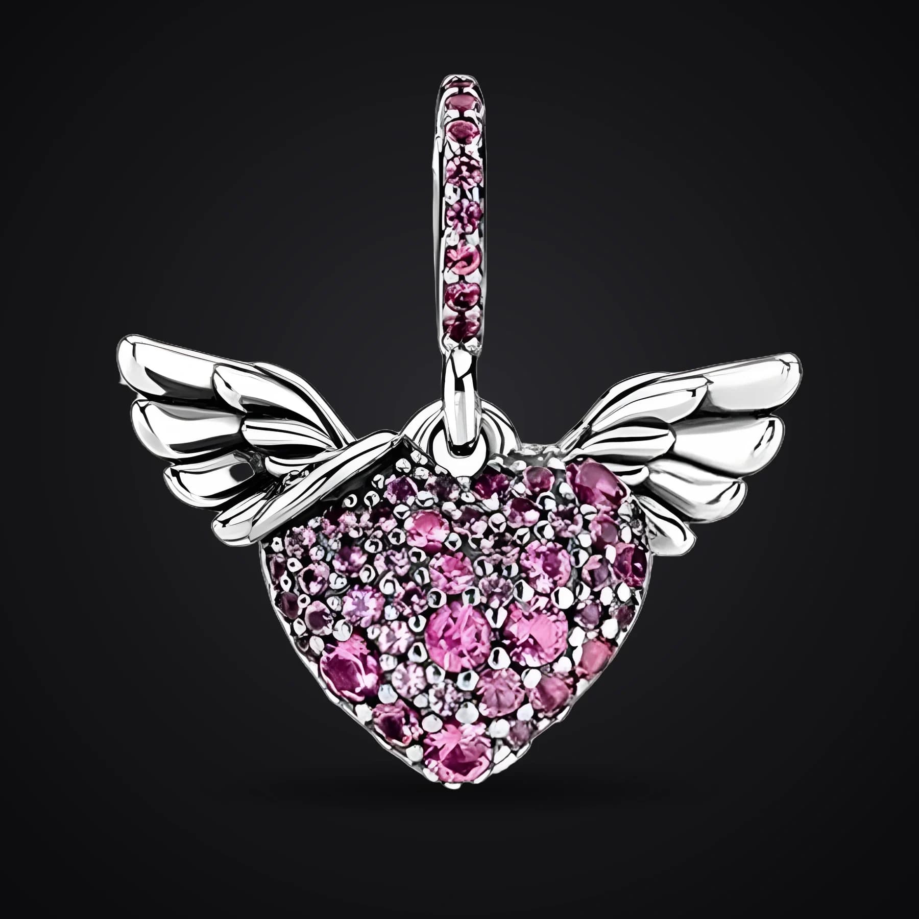 Winged Heart charm on a dark background