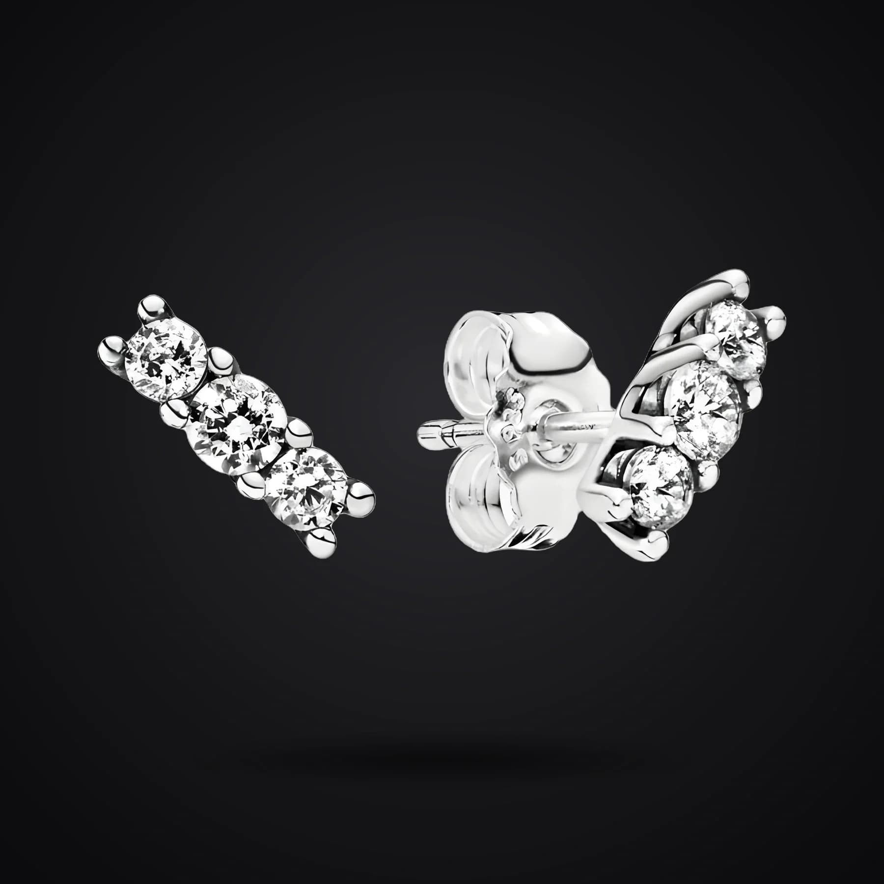 Pavé Line earrings on a dark background