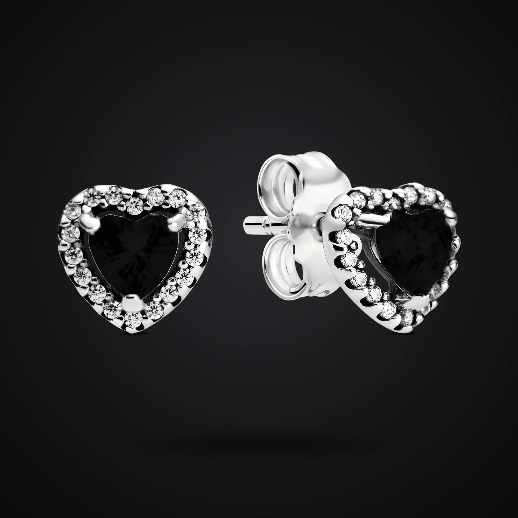 Black Hearts earrings on a dark background