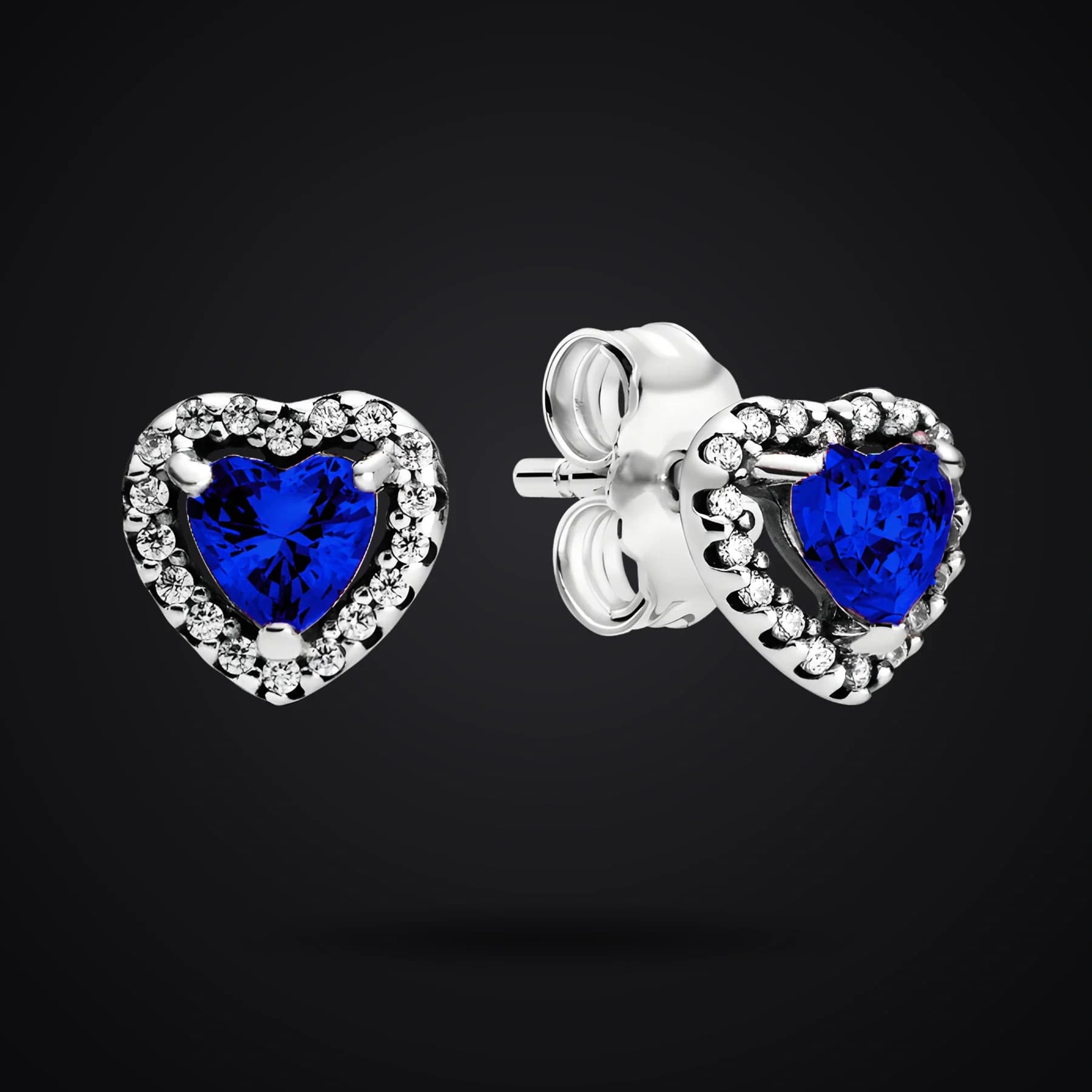 Blue Hearts earrings on a dark background