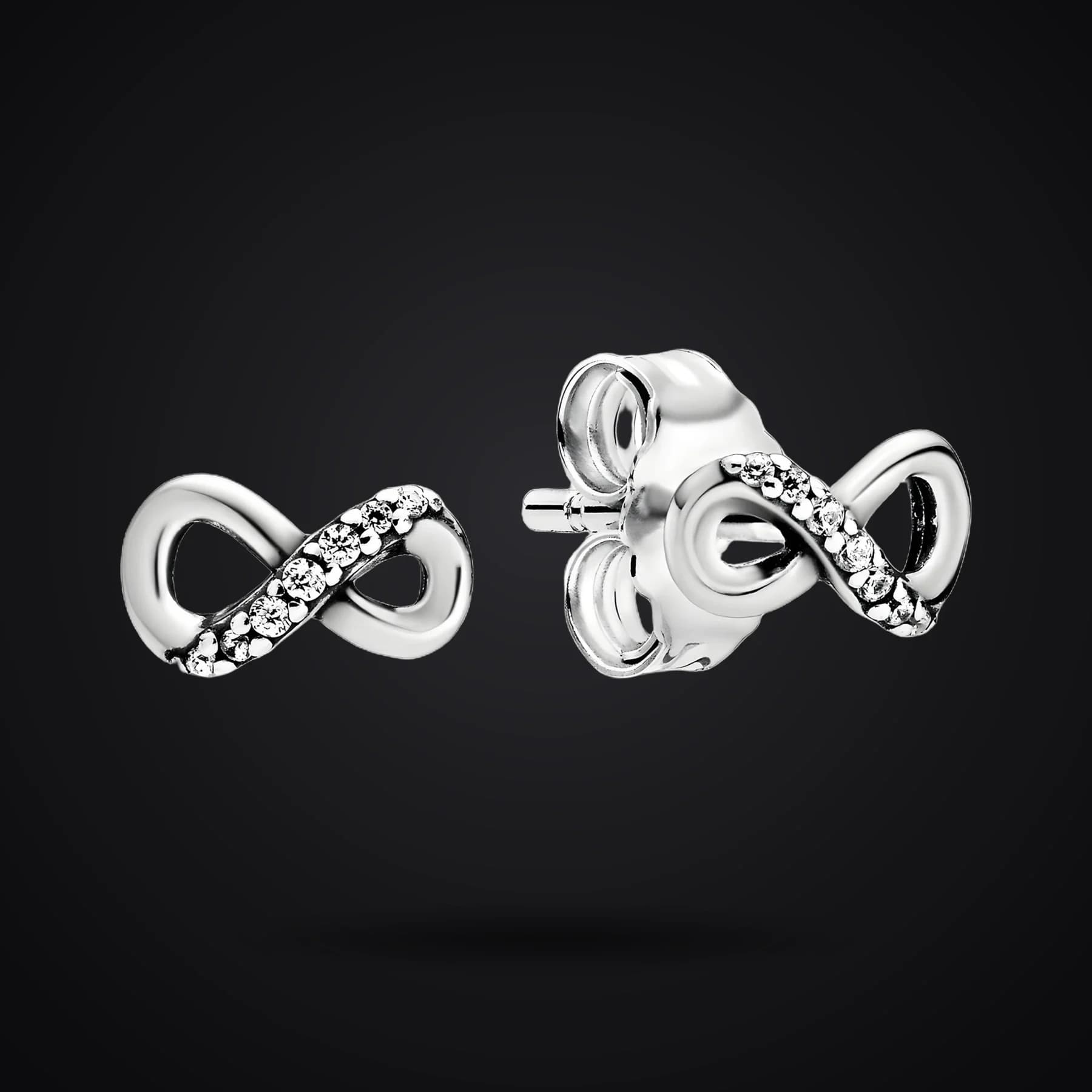 Infinity earrings on a dark background