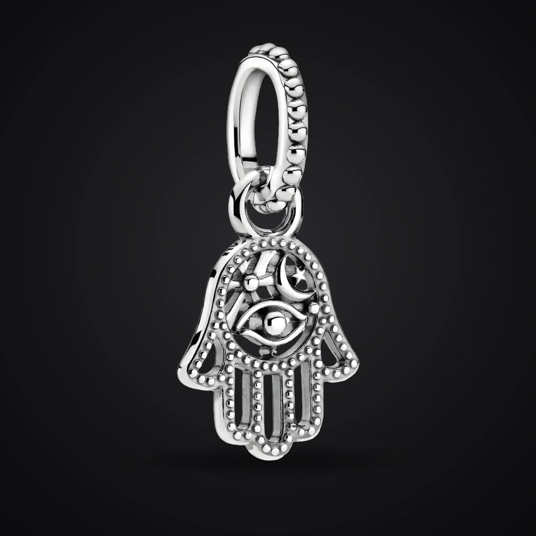 Hamsa charm on a dark background