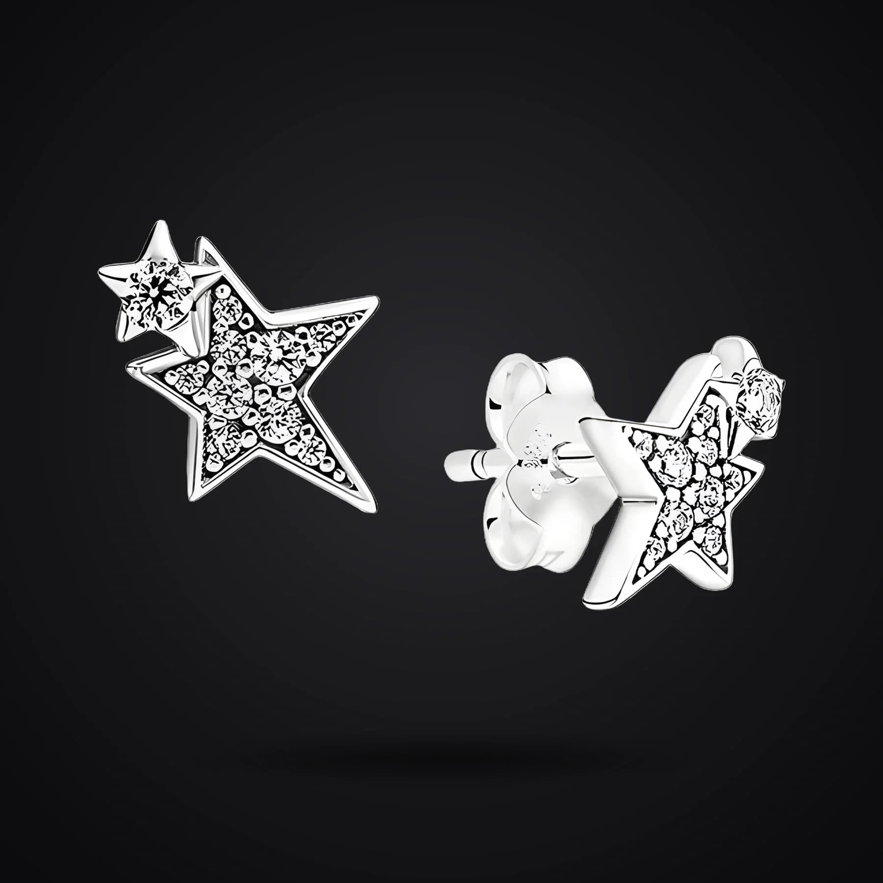 Asymmetric Stars earrings on a dark background