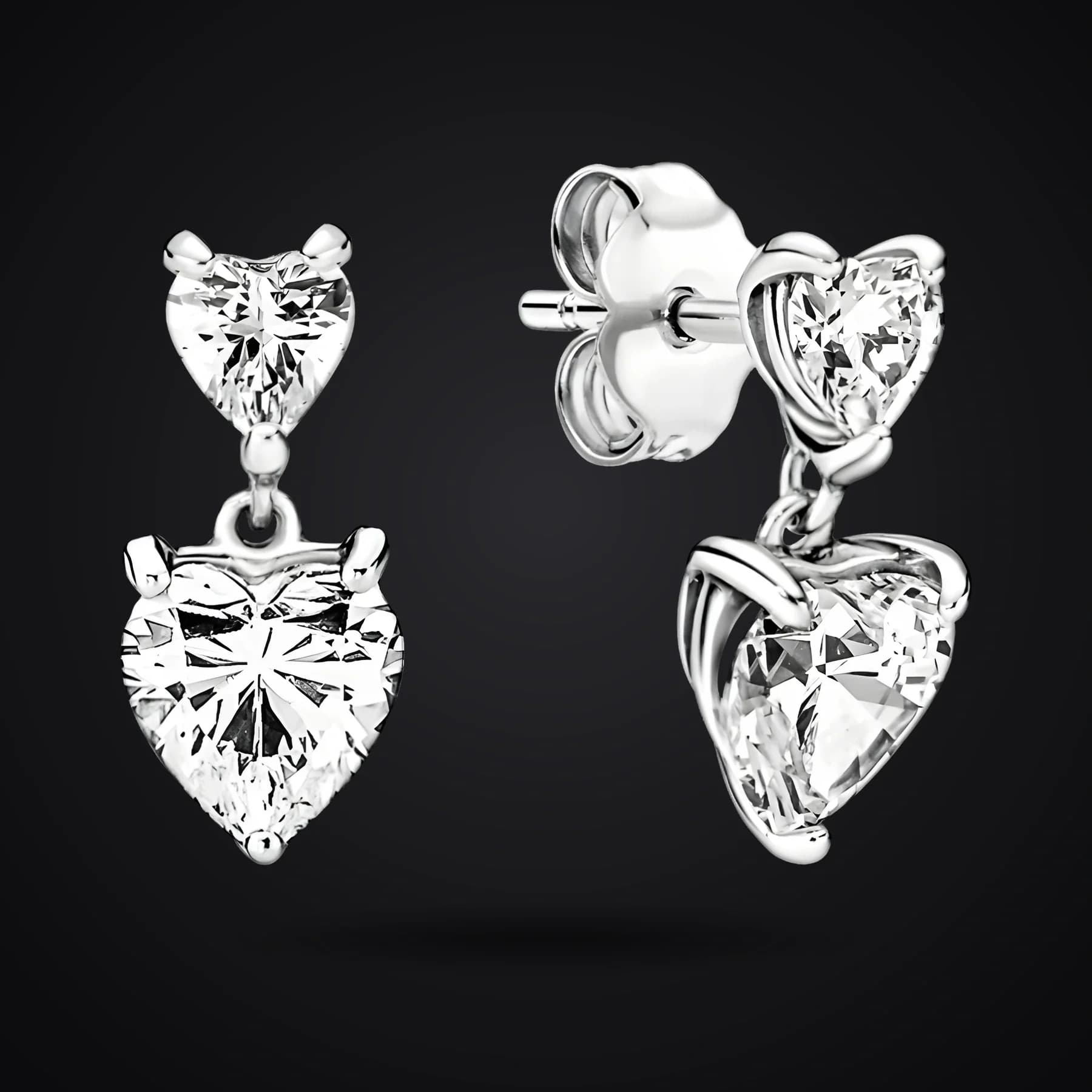 Two Hearts earrings on a dark background