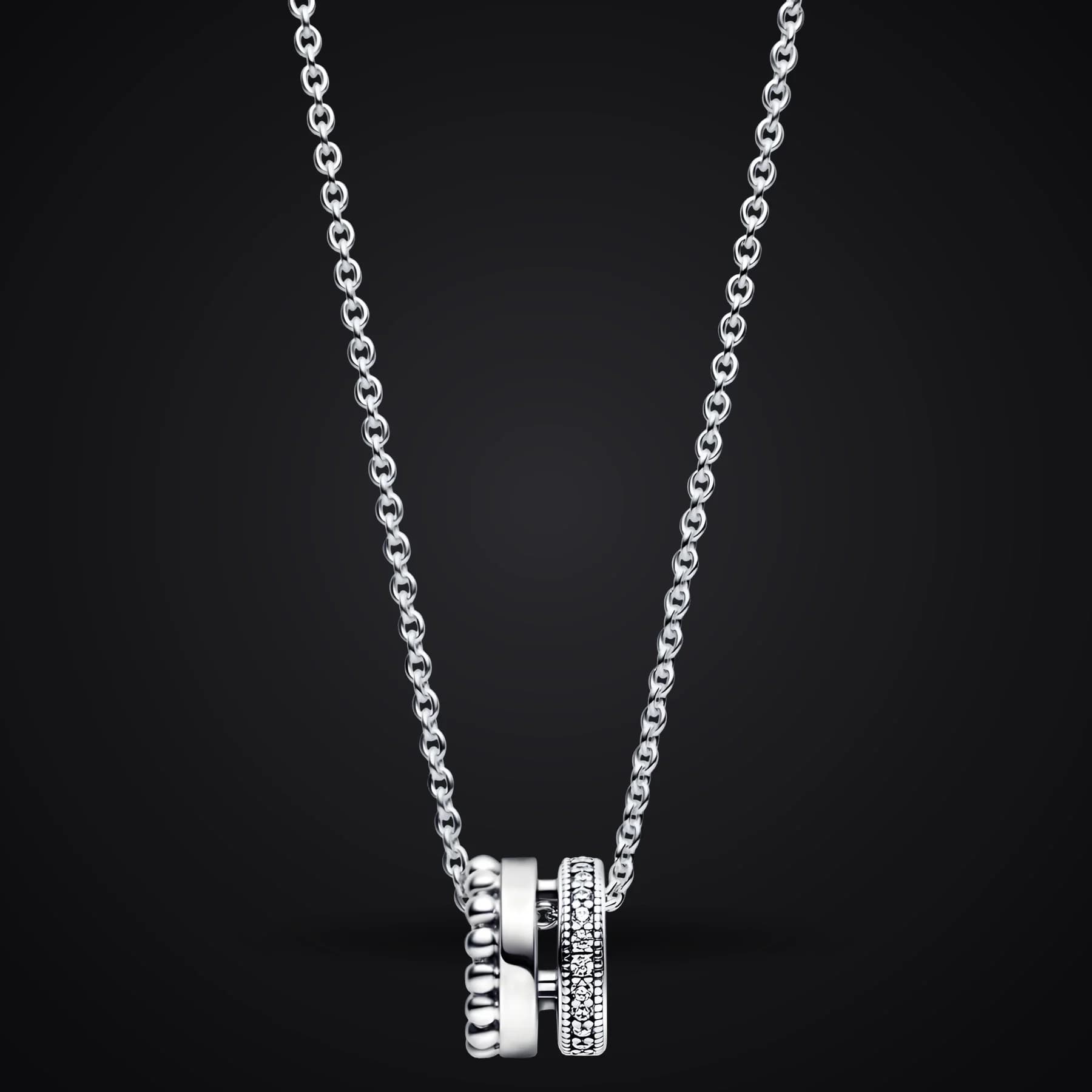 Crown Slider necklace on a dark background