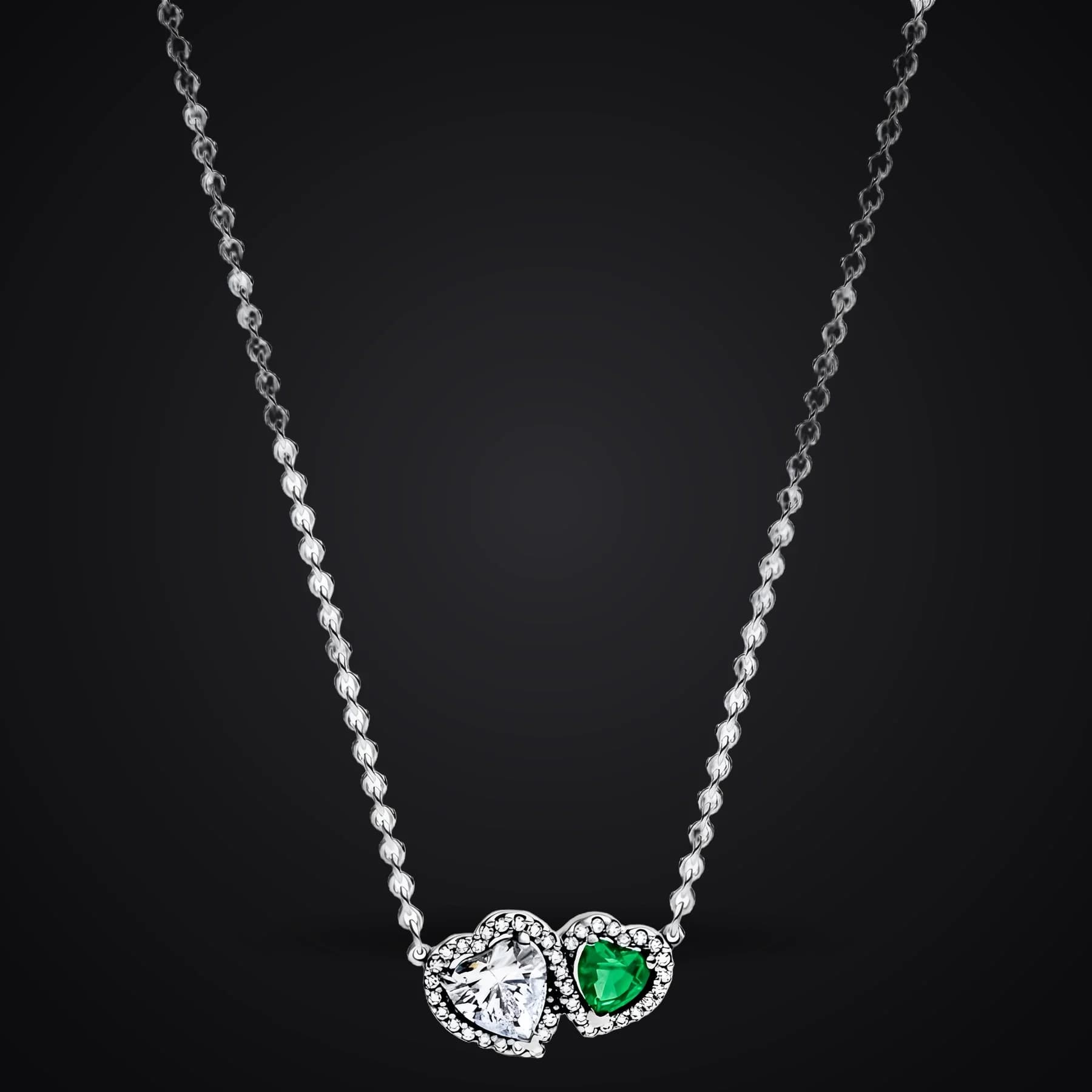 Harmony Hearts necklace on a dark background