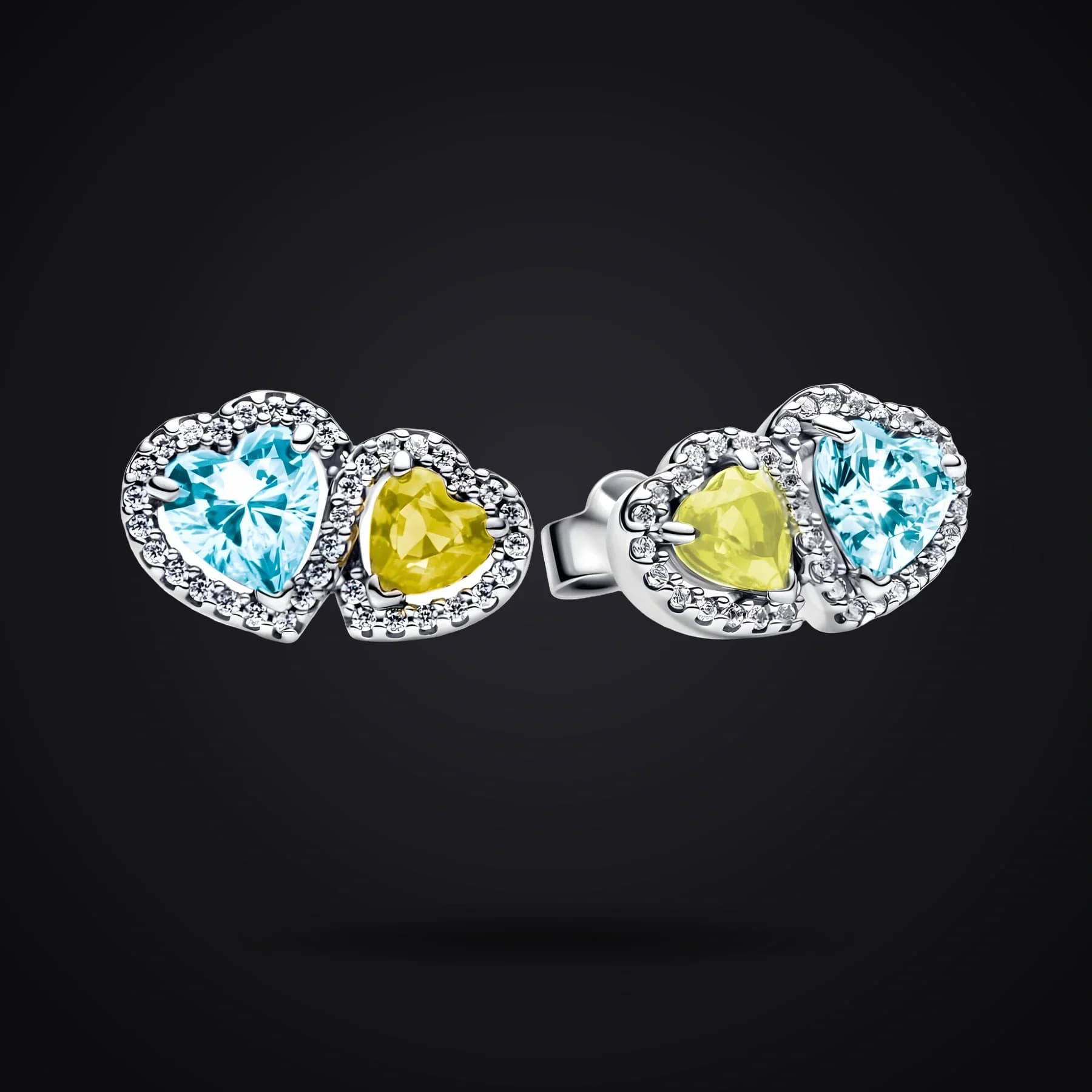 Harmony of Light earrings on a dark background